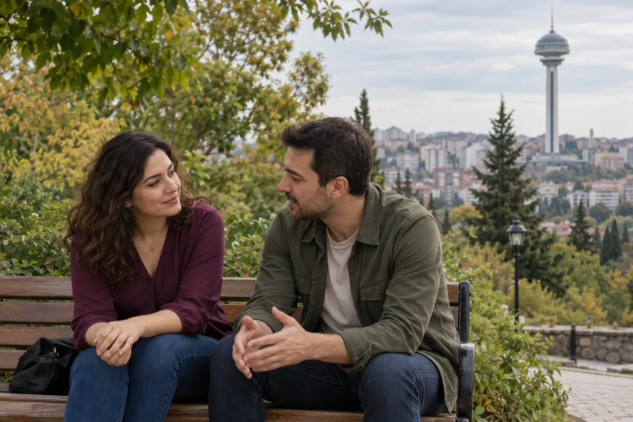 An adult couple in everyday clothes discusses appointment plans near Botanik Park in Ankara with Atakule visible in the distance.